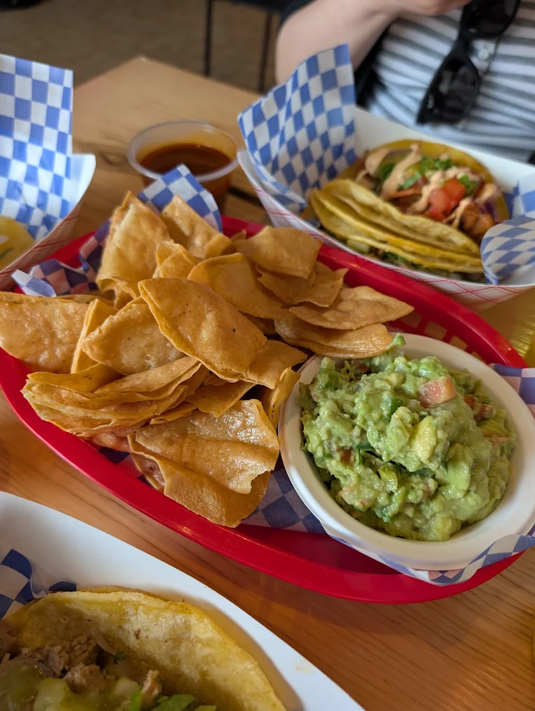 Fresh guacamole and a basket of crisp tortilla chips