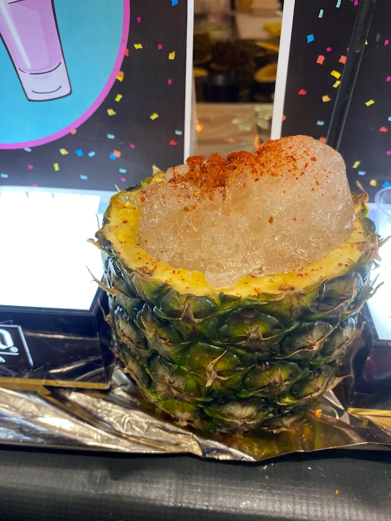 A frozen drink served in a fresh pineapple at Piñata Tacos