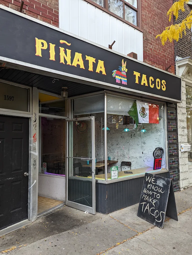 The Piñata Tacos storefront at 1597 Dundas West, with a Mexican flag in the window